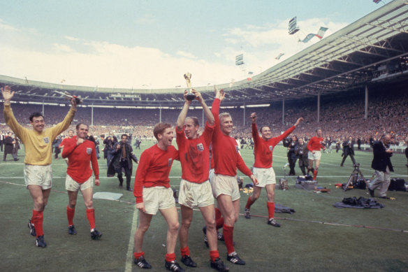 Bobby Charlton raises the Jules Rimet trophy in the air  following England’s 4-2 victory after extra time over West Germany in the World Cup Final in 1966.