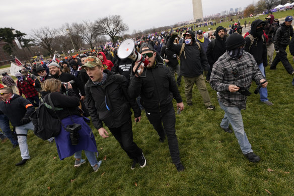 Ethan Nordean, with backward baseball hat and bullhorn, leads members of the far-right group Proud Boys in marching before the riot at the US Capitol. 