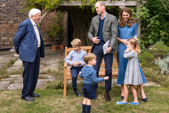 Prince William, Catherine, Duchess of Cambridge, Prince George (seated), Princess Charlotte and Prince Louis meet with Sir David Attenborough in the gardens of Kensington Palace, in this picture released by the royal family.