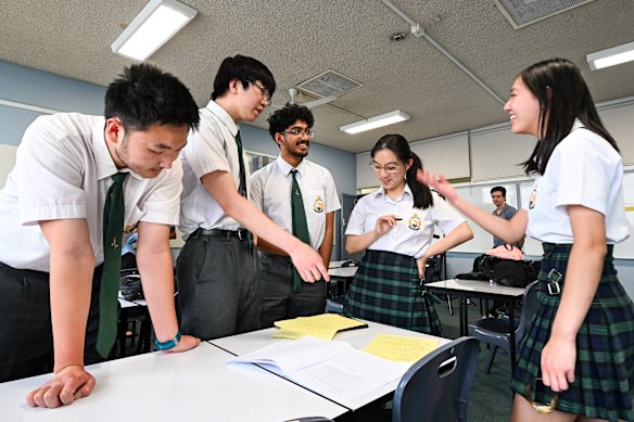 James Ruse Agricultural High School students Terry Chen, Peter Shan, Nikil Andepalli, Emily Xiao and Selina Ma compare notes after the maths extension 2 paper.