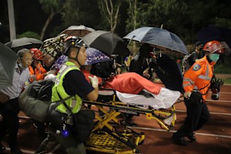 Medical workers move an injured student following clashes with police at the Chinese University in Hong Kong.