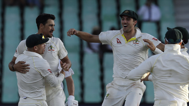 Mitchell Starc celebrates with teammates after bowling South Africa's batsman Morne Morkel, for a duck.