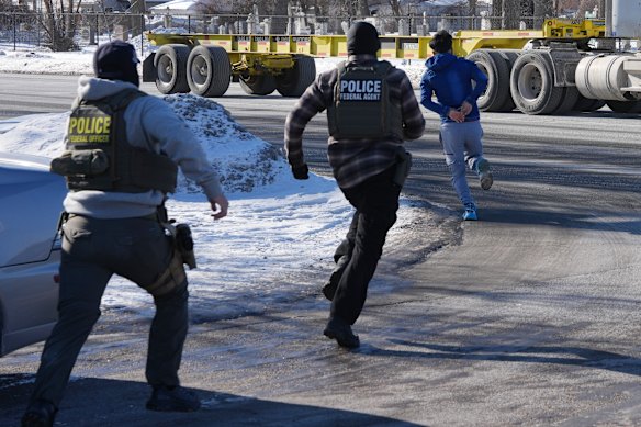 A man in handcuffs runs to avoid being detailed by federal immigration agents on Tuesday, Jan. 27, 2026, in Minneapolis. 