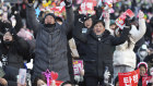 South Koreans gathered outside the National Assembly in Seoul to celebrate after parliament voted to impeach the president. 