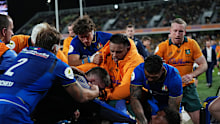 Marco Riccioni of Italy scuffles with Miles Amatosero of the Wallabies on the sideline.