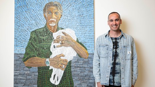 Former refugee Mostafa Azimitabar with his portrait of Angus McDonald, which is a finalist in the Archibald Prize at the Art Gallery of NSW.