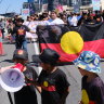 Yes vote supporters march through Brisbane on Sunday.