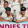 Australia players pose with the trophy after day day three of their third Test cricket match against West Indies at Sabina Park in Kingston, Jamaica, 