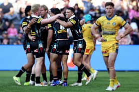 Penrith celebrate one of many tries against the Eels on Saturday.