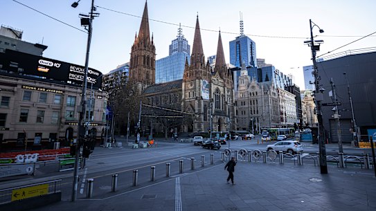 A person walks at a very quiet Flinders Street Station on Wednesday.