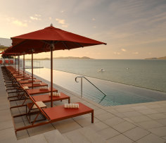 Ardo’s rooftop pool and bar look across to the Coral Sea and Magnetic Island.