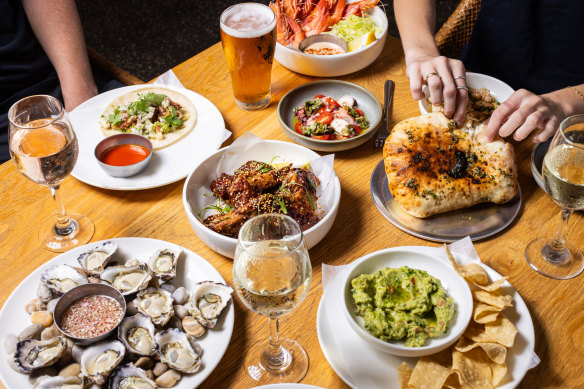 Oysters, smoked pork taco, corn chips and guacamole, and flatbread.