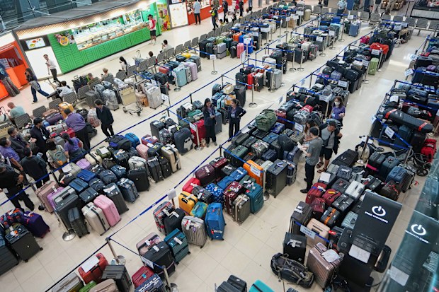 Rows of undelivered luggage are placed in the arrivals hall at Suvarnabhumi International Airport in Samut Prakan, Thailand, Tuesday, Sept. 29, 2026, after heavy rain and floods in Bangkok prevent airport workers from getting ito work.