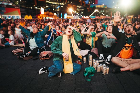 Soccer fans watch the match in suspense as the game intensifies during the first half, at Darling Harbour in Tumbalong Park.