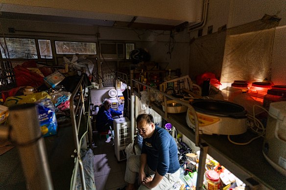 Resident Law Chung-yu sits in his bed space in Sham Shui Po district of Hong Kong.