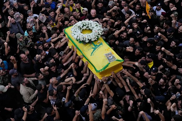 The funeral of a Hezbollah militia member killed when his handheld device exploded last year. 