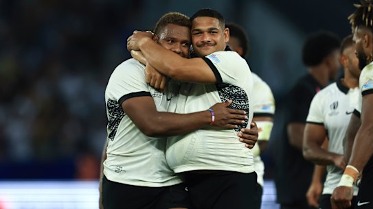 Fiji’s Ilaisa Droasese and Samuel Matavesi embrace after defeating the Wallabies.