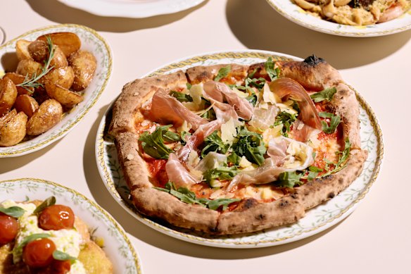 Prosciutto pizza with rocket and cherry tomato.