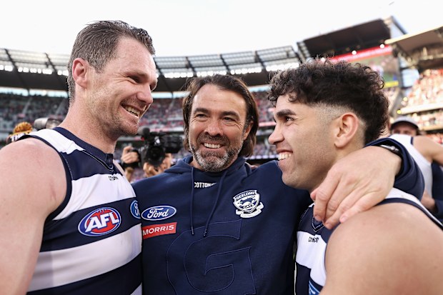 Patrick Dangerfield, Chris Scott and Tyson Stengle celebrate Geelong's 2022 grand final win.