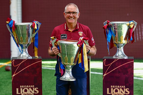 Retiring coach Chris Fagan with his three Lions premiership cups.