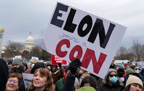 People protest during a rally against Elon Musk outside the US Department of Labour in Washington.