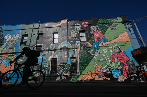 Cycling past a mural in Brougham Street.