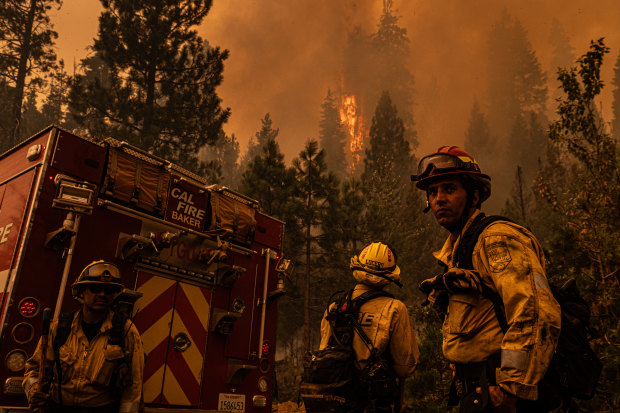 A CalFire crew assesses a spot fire near Mill Creek, California.