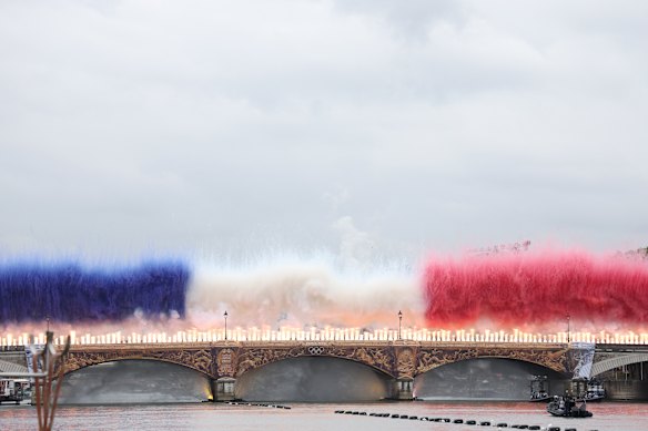 Pyrotechnics in the colours of the French flag mark the start of the ceremony. 