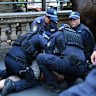 NSW police detain a protester.