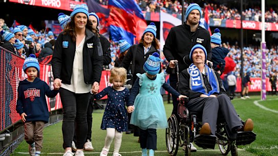Neale Daniher and his family complete a lap of honour at the MCG before Monday’s Big freeze match between Melbourne (the team he used to coach) and Collingwood.