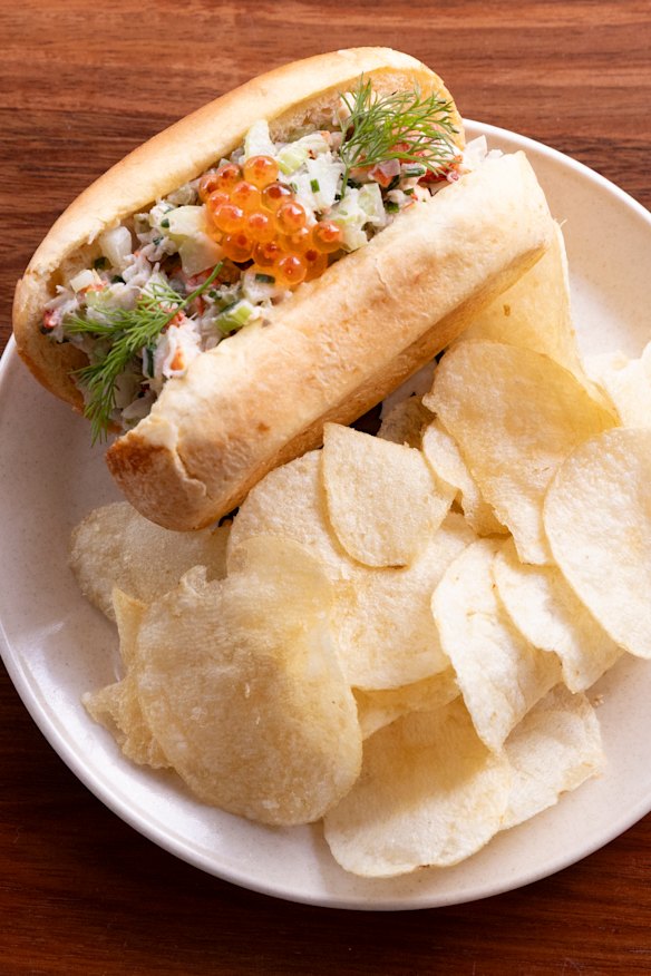 The lobster roll served on a brioche bun with salmon caviar and crisps.