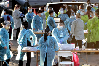 Medical personnel prepare to test hundreds of people lined up in Phoenix in the US on the weekend.