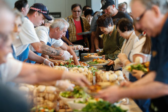 The crowd fill their plates at Collingwood Football Club’s annual Christmas Day luncheon in 2019.