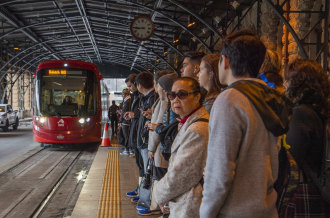 Passengers wait for the Inner West light rail at Central Station pre-COVID.