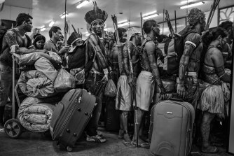 Members of the Munduruku community line up to board a plane at Altamira Airport, in Pará, Brazil, in June 2013.