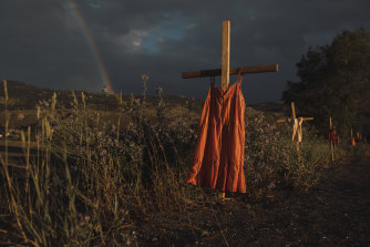 Red dresses hung on crosses commemorate children who died at the Kamloops Indian Residential School. 