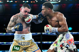 George Kambosos cops some punishment from Devin Haney during their title fight at Marvel Stadium on Sunday.