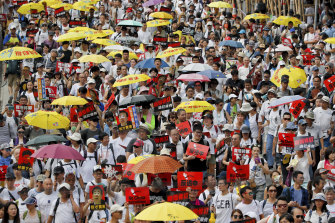 Protesters holding umbrellas and placards take part in the rally against the extradition law in Hong Kong.