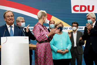 German Chancellor Angela Merkel receives applause during the Christian Democratic Union (CDU) election event, as voters go to the polls. 