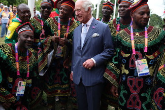 Britain’s Prince Charles poses with athletes and members of the team from Cameroon.