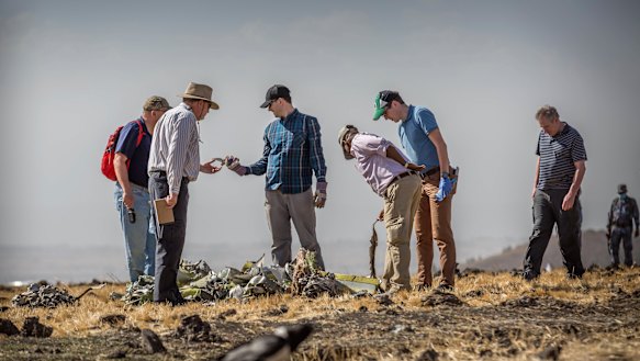 Foreign investigators examine wreckage at the scene where the Ethiopian Airlines Boeing 737 Max 8 crashed shortly after takeoff near Bishoftu, south of Addis Ababa, in Ethiopia.