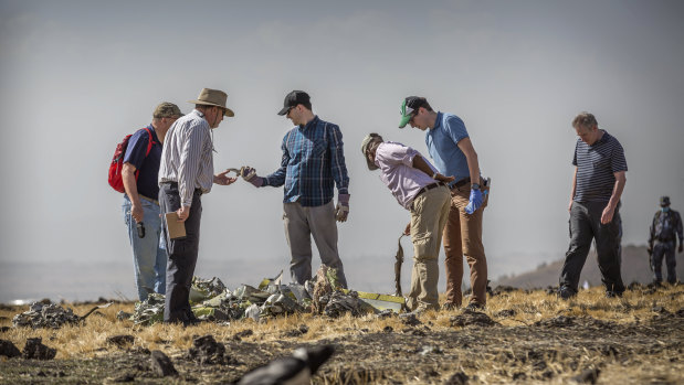 Foreign investigators examine wreckage at the scene where the Ethiopian Airlines Boeing 737 Max 8 crashed shortly after takeoff near Bishoftu, south of Addis Ababa, in Ethiopia.