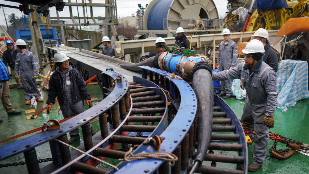 A repeater used to connect sections of fibre-optic cable is loaded onto the Durable in New Hampshire.