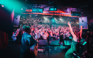 Waveney Yasso, left, and Astrid Jorgensen lead the Pub Choir audience in a song at Corner Hotel, Richmond, October 2018. 