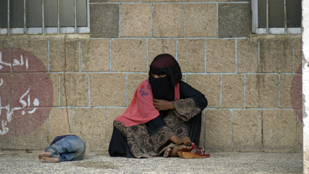 A displaced Yemeni woman and her child fled their home because of the fighting in Hodeida. Here they sit in a school allocated for displaced people in Sanaa, Yemen, in June.