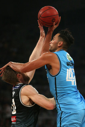 Spoiler alert: Former United player Tai Wesley attempts to shoot over Melbourne's David Barlow.