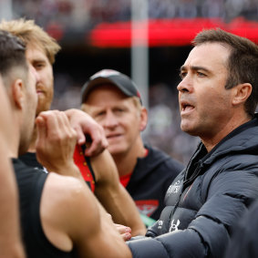 Bombers coach Brad Scott addresses his charges at quarter-time.