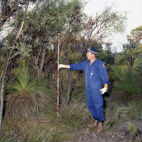 Former forensic supervisor Robert Hemelaar measuring where tree branches had been ripped off near where Ciara's body was found. 