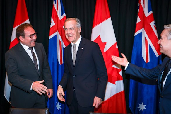 Canadian Prime Minister Mark Carney (centre) with Assistant Treasurer Daniel Mulino (left) and Canadian Finance Minister Francois-Philippe Champagne.