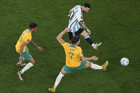 Argentina’s Lionel Messi makes a shot as Australia’s Mathew Leckie tries to block.